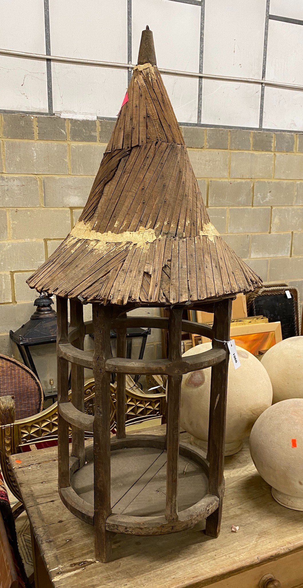 An Eastern wood bird house (?), diameter 47cm, height 130cm